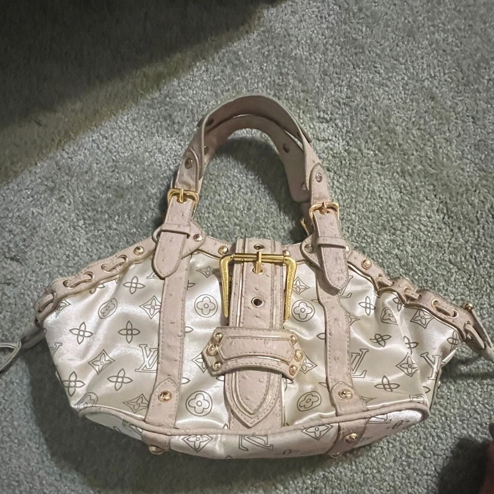Handbag monogram with large gold buckle . Cream leather handle & suede lining.
